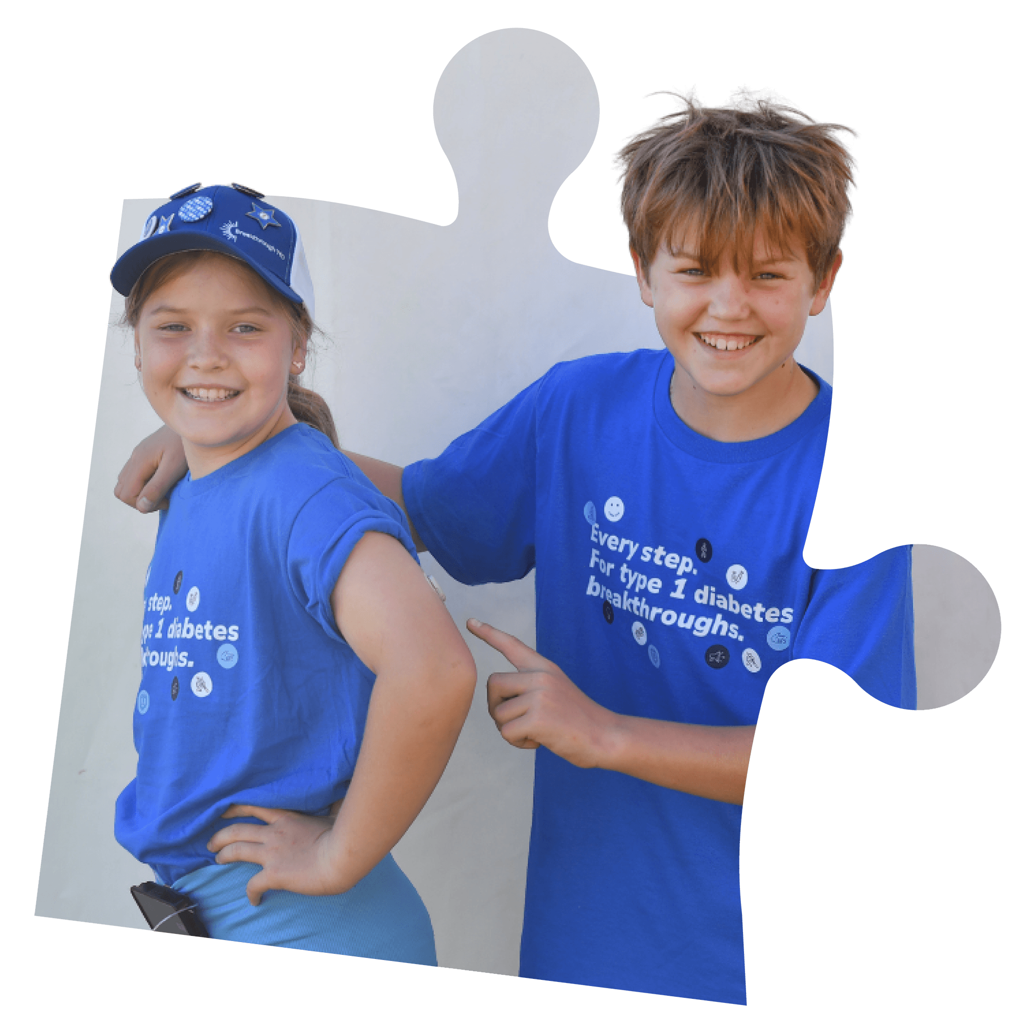 A boy and girl wearing Breakthrough T1D shirts, smiling