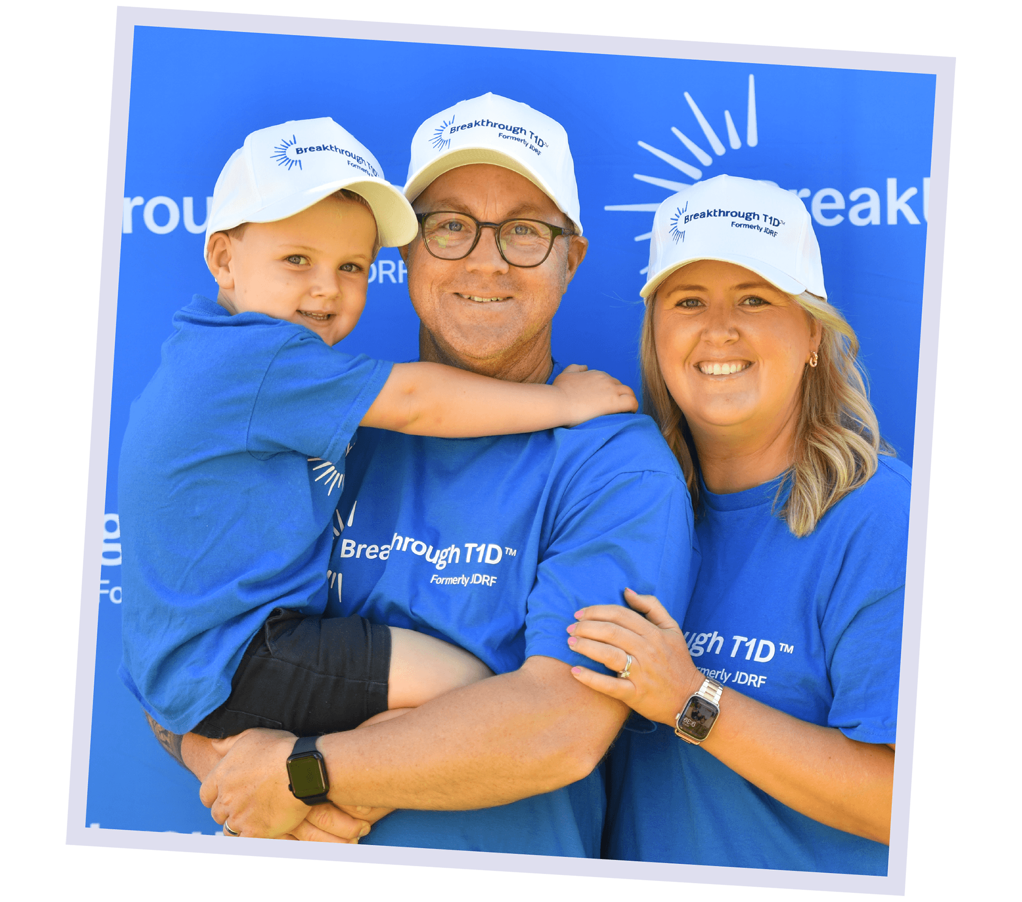 Fletcher and his parents, smiling at the camera in Breakthrough T1D shirts. 