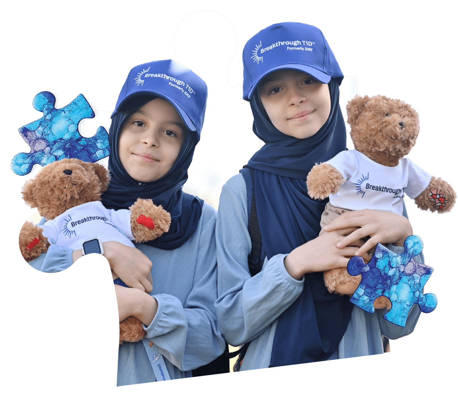 2 girls holding Rufus teddy bears, smiling at the camera
