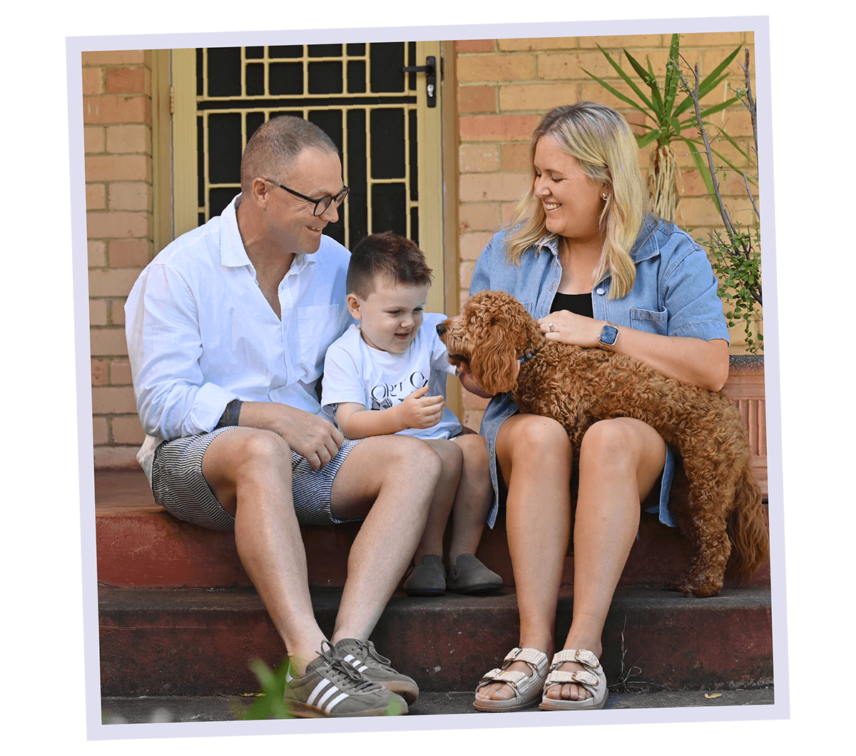 Fletcher and his parents with a dog
