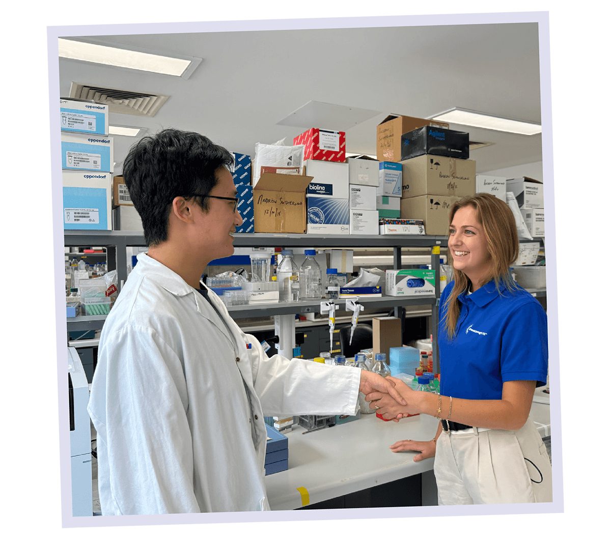 Dr Lai shaking hands with a Breakthrough T1D staff member in the lab